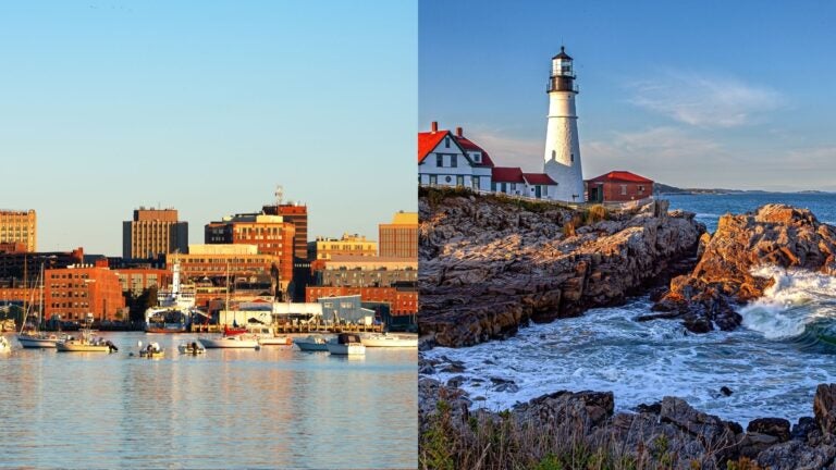 Portland’s waterfront with moored boats alongside Portland Head Light on a rocky shoreline.
