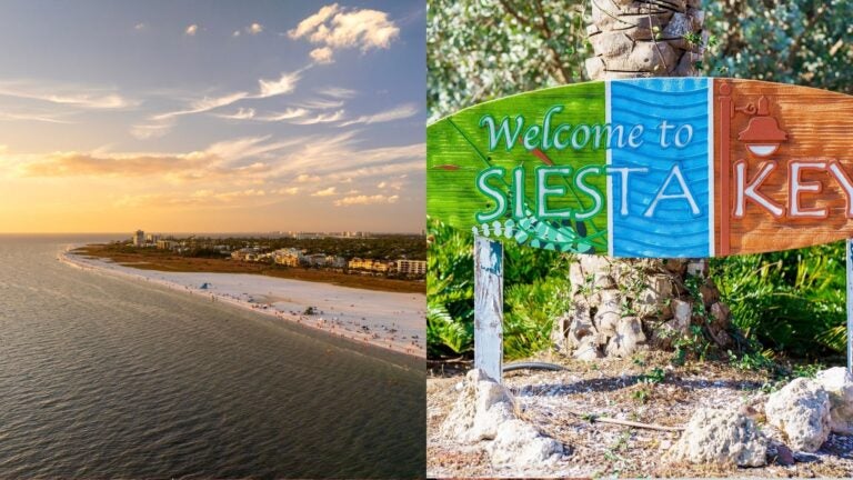 Aerial view of Siesta Key’s sandy shoreline at sunset, beside a colorful “Welcome to Siesta Key” sign.