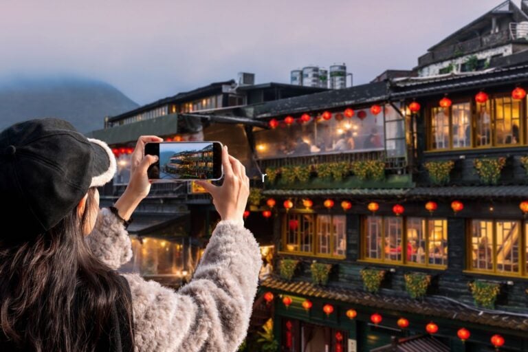 Tourist enjoying the night view of Jiufen old street in Taiwan.