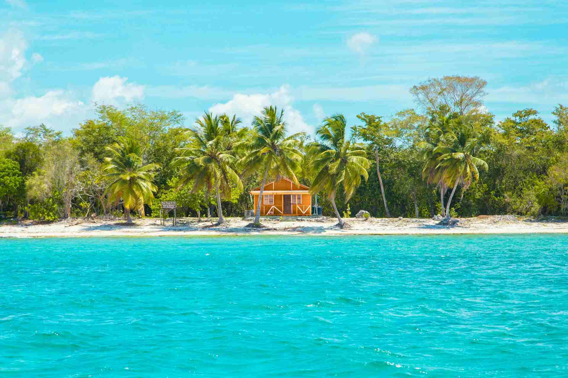 Foto einer Holzhütte am Strand in der Nähe von Kokosnussbäumen in La Altagracia, Dominikanische Republik