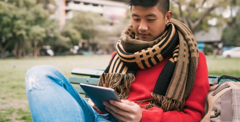 Joven usando un dispositivo móvil con una Tarjeta SIM en Nepal