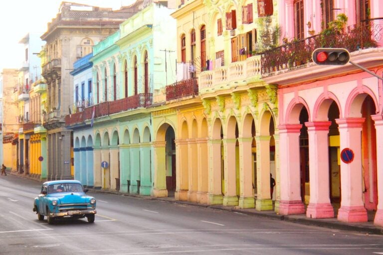 Auto en la habana cuba frente a edificios tradicionales de varios colores