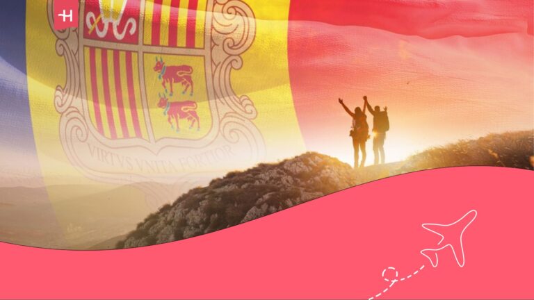 Dos personas en una montaña en Andorra y la bandera del país al fondo