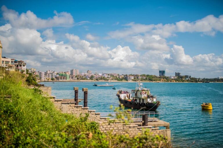 Vue panoramique sur le littoral de Mombasa et ses bateaux sous un ciel bleu au Kenya.