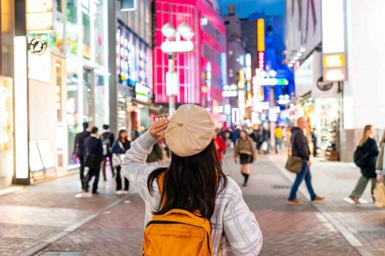 Ragazza viaggiatrice che si gode e acquista in Shibuya street a Tokyo
