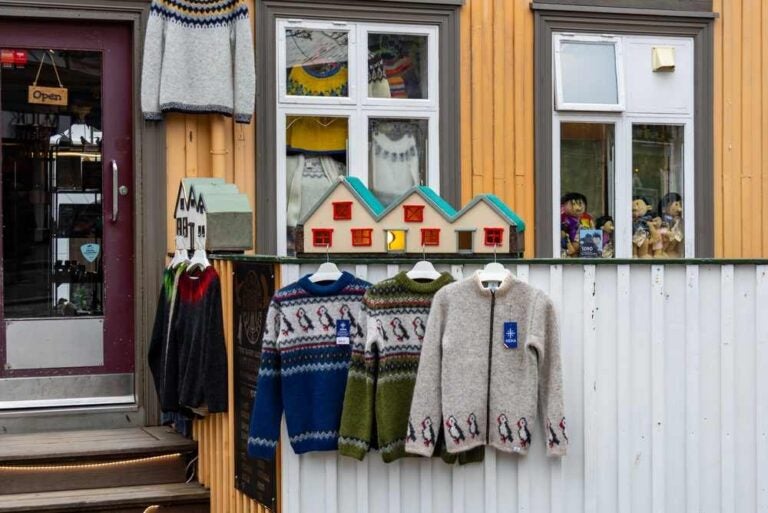 Maglioni di lana islandese Lopapeysa con motivi in puffin Fratercula arctica appesi fuori dal negozio a Reykjavik Islanda