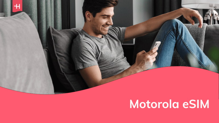 Foto van een glimlachende man op de bank met een smartphone in de hand als uitgelichte afbeelding voor een pagina over de Motorola eSIM