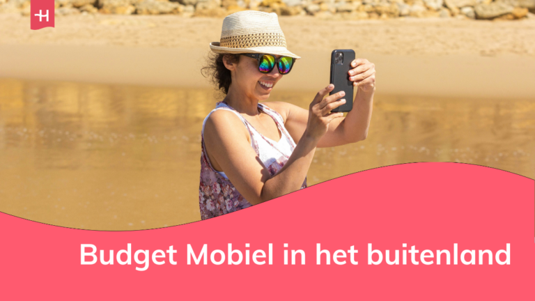 Foto van een vrouw die een foto neemt op het strand als uitgelichte afbeelding voor een pagina over Budget Mobiel in het buitenland