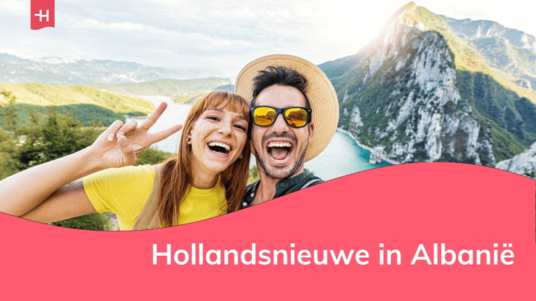 Foto van een lachend koppel dat poseert voor een berglandschap als uitgelichte afbeelding voor een artikel over Hollandsnieuwe in Albanië