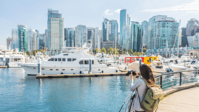 Vrouw neemt een foto van de skyline van Vancouver bij Coal Harbour 