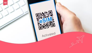 Persoon houdt een telefoon vast met het woord "eSIM" op het scherm als uitgelichte afbeelding voor een Kolet eSIM review