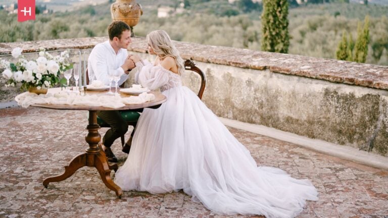 Getrouwd koppel poseert op een terras in Toscane