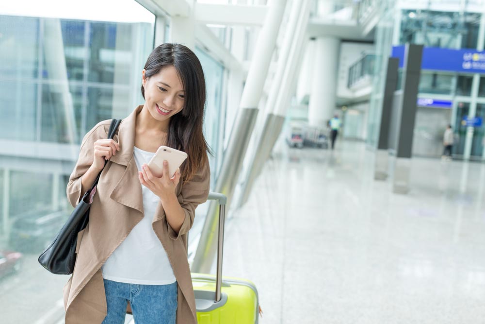 airport-woman-using-phone.jpg