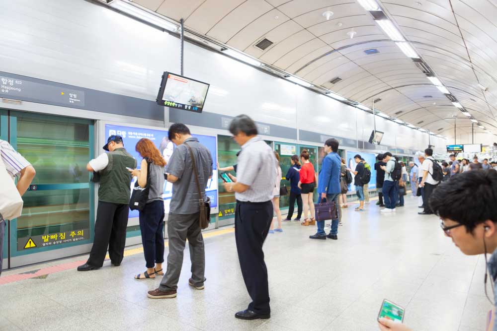 ソウルの地下鉄駅・合井(ハプチョン)駅のホームで、列車を待つ多くの乗客たちの様子。