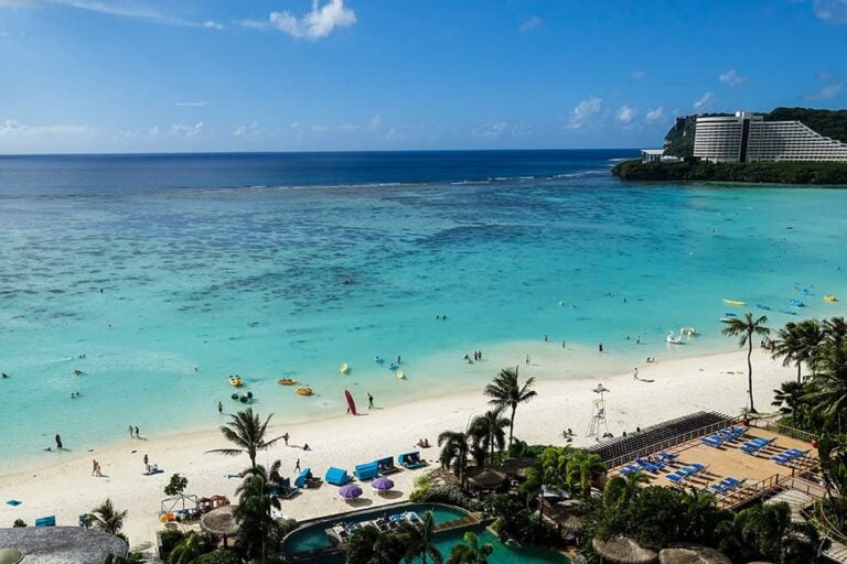 グアムのタモンビーチに広がる青い海と白砂のビーチ、3泊4日の短期リゾート旅行で海時間を楽しめる風景