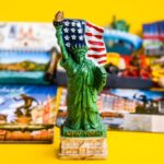 アメリカ・ニューヨーク限定の自由の女神フィギュア型マグネットを中心に、世界各国の観光マグネットが並べられた様子。
