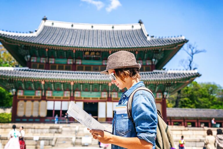 韓国の宮殿前で地図を見ながら観光を楽しむ旅行者