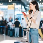 空港でスーツケースを持ちスマホを確認する女性旅行者。日本人のアジア旅行先は韓国・台湾・シンガポールが人気という調査記事のサムネイル。