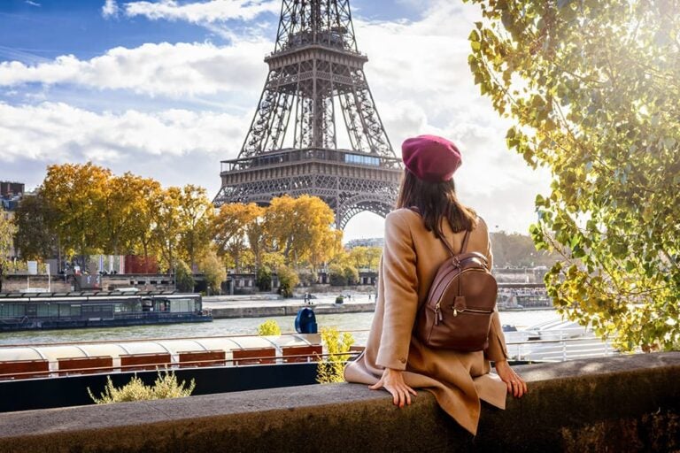 セーヌ川沿いからパリのエッフェル塔を眺める旅行者