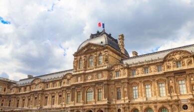 フランス国旗が掲げられたパリのルーブル美術館の外観