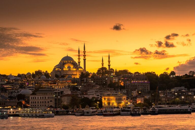 黄金色の夕焼けに染まるトルコの都市イスタンブールで、美しい夕日スポットとして知られる水辺から望む壮麗なモスクと街並みのシルエット風景