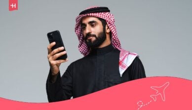 رجل يستخدم هاتفه المحمول أثناء تفعيل خدمة التجوال الدولي في قطر