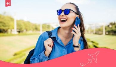 فتاة تتحدث عبر هاتفها بسعادة في الهواء الطلق كمثال على تجربة استخدام Vodafone eSIM أثناء التنقل