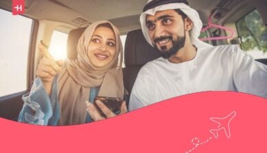زوجان سعيدان يقودان السيارة في دبي.